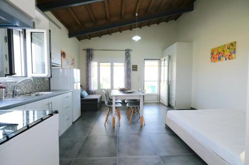a kitchen with a bed and a table in a room at Thealassa in Kalliópi