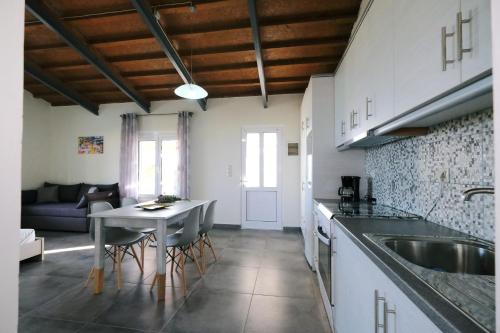 a kitchen and living room with a table and a sink at Thealassa in Kalliópi