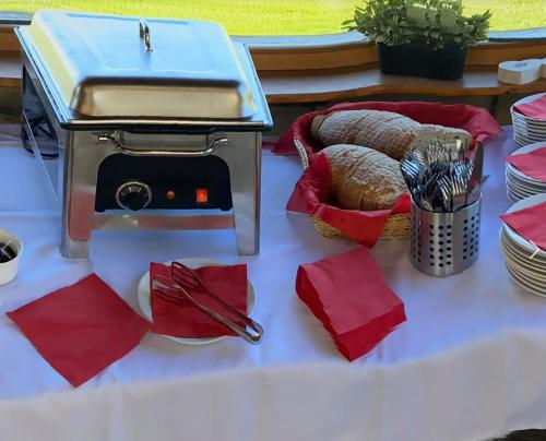 a table with a grill and bread on it at Ranch Jestřebice in Heřmaničky