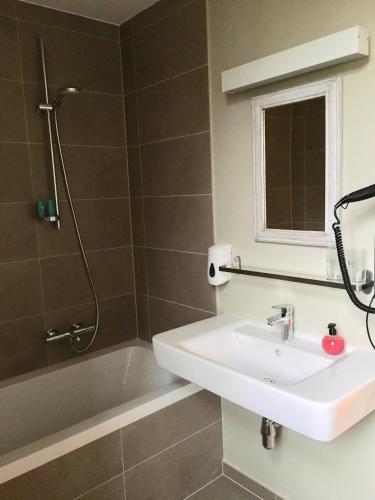 a bathroom with a sink and a shower at Orshof in Oudsbergen 