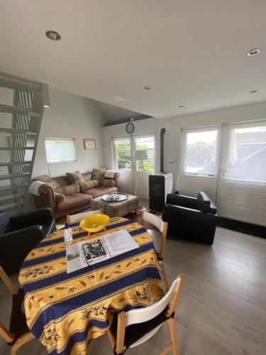 a living room with a table and a couch at Aan de Vecht in Nederhorst den Berg