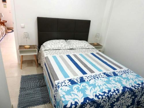 ラゴスにあるA Nossa Casinhaのベッドルーム1室(青と白の掛け布団付きのベッド1台付)