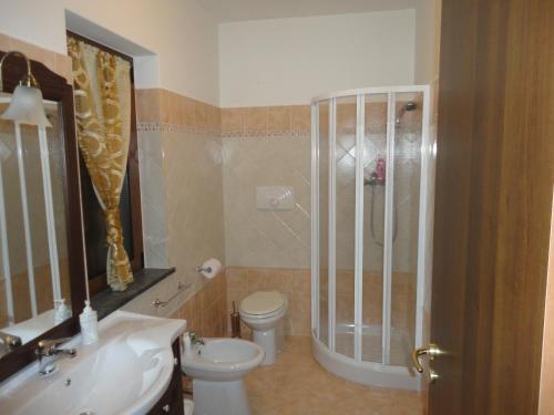 a bathroom with a shower and a toilet and a sink at Green House in Morano Calabro