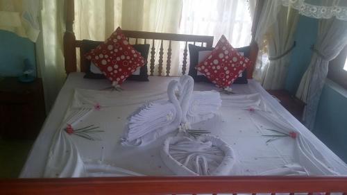 a bed with two white swans on it at Madoldu eco resort in Koggala
