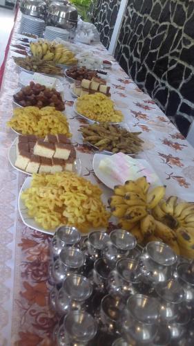a long table with many plates of food on it at Madoldu eco resort in Koggala
