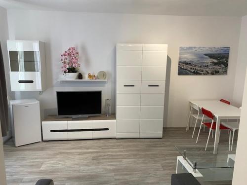 a living room with a television and a white cabinet at Miasto Gdynia in Gdynia