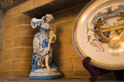 a statue of a woman on a wall next to a clock at The Gastonian, Historic Inns of Savannah Collection in Savannah