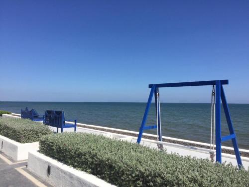 a swing set on the beach with the ocean at The Crest Santora Huahin 4 Fl H(Monthly rate) in Hua Hin