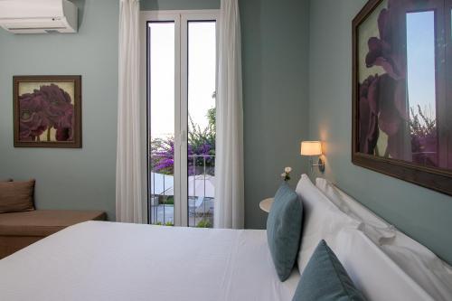 a bedroom with a white bed and a large window at Blu Hotel in Lavagna
