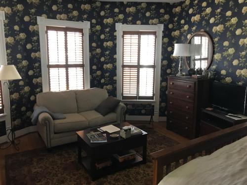 a living room with a couch and a television at Charles Bass House Bed & Breakfast in South Boston