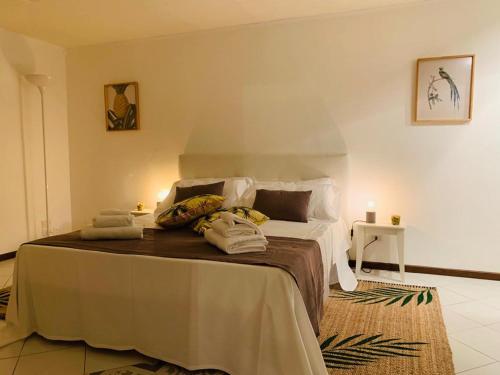 a bedroom with a large bed with towels on it at Pancrazio in Taormina