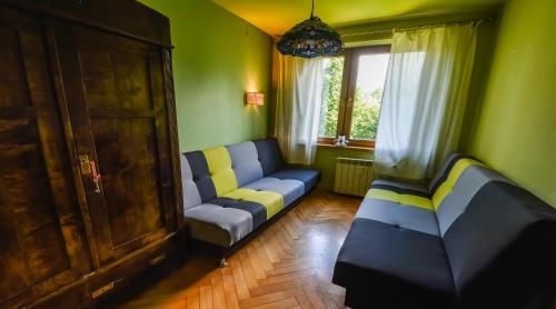 a living room with a couch and a window at Rent like home - Słoneczna 3 in Zakopane