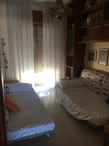 A bed or beds in a room at Appartamento Capo d'Orlando