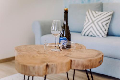 a table with two glasses and a bottle of wine at Nádas Center Home Badacsony in Badacsonytomaj