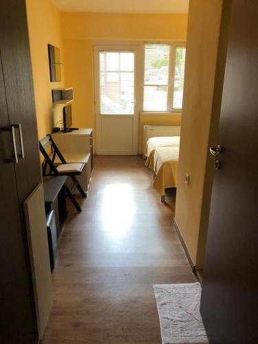 a hallway of a room with two beds and a window at Хотел Хисаря in Haskovo