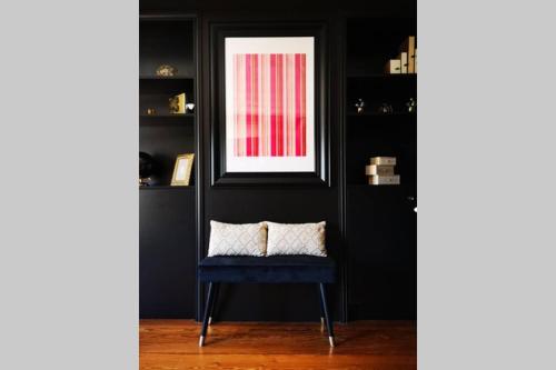 a window in a black room with a blue chair at Le Boudoir in Lyon