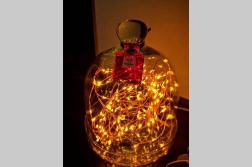 a glass bottle filled with lights on a table at Le Boudoir in Lyon