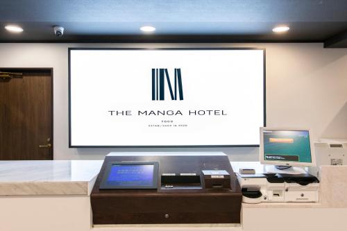 an office with a printer and a computer on a screen at THE MANGA HOTEL TOGO in Togo