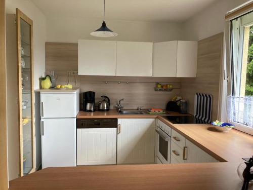 a kitchen with white cabinets and a sink at an der Liesel Wiese in Johanngeorgenstadt