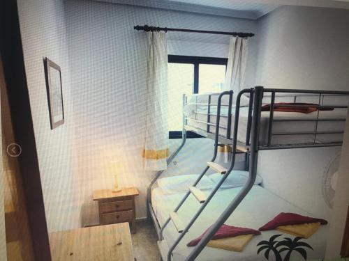 a bunk bed in a room with a window at Playamarina 2 Cabo Roig in Playas de Orihuela