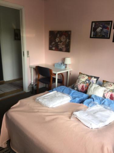 a bed in a room with a table and a table at Hostel Agger Vandrerhjem in Agger