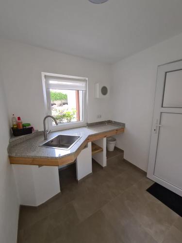 a kitchen with a sink and a window at Wohnen im Springerhof in Lohr