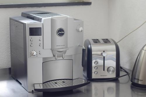 a coffee maker and a toaster on a counter at Appartements am Bodensee Nähe Konstanz in Ermatingen