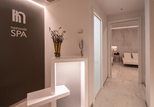 a lobby of a spa with a vase on a counter at Best Western Hotel Nazionale in Sanremo