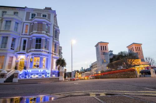 a building with blue lights on a city street at The Mowbray in Eastbourne