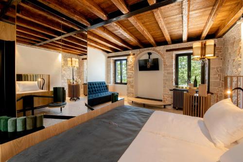 a bedroom with a bed and a living room at Spirito Santo Palazzo Storico - Adults Only in Rovinj