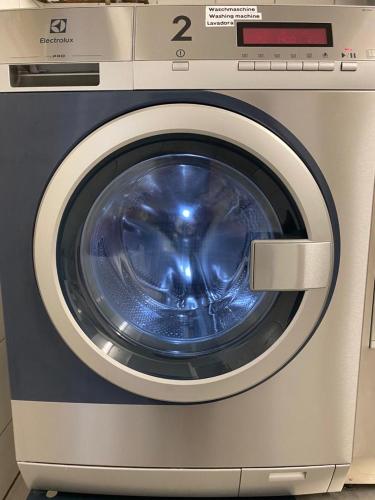 a close up of a washing machine in a room at Gästehaus Kral in Erlangen