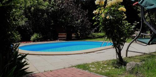 a swimming pool in a yard with a tree at Apartment Ulrich in Jablonec nad Jizerou