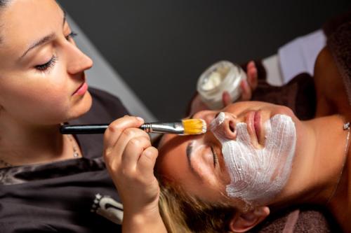 a woman applying makeup on a mans face at Best Western Hotel Nazionale in Sanremo