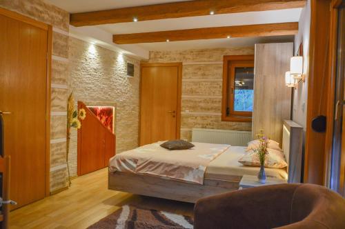 a bedroom with a bed and a chair in it at Apartments Josipovic in Zlatibor
