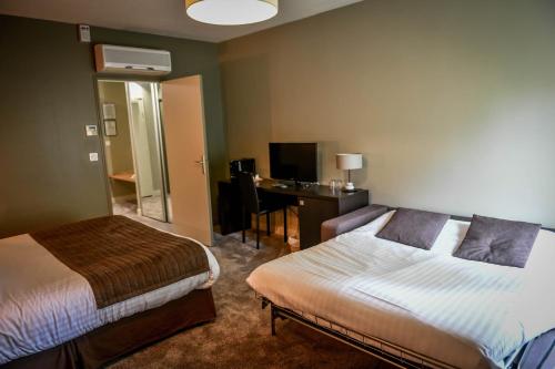 a hotel room with two beds and a desk at Chateau du Clos de la Ribaudiere - Teritoria in Chasseneuil-du-Poitou