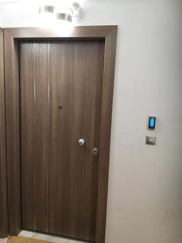 a wooden door in the corner of a room at Amazing Apartments @ Monastiraki Subway Station in Athens