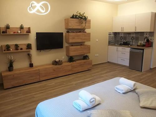 a room with a kitchen and a bed with towels at Amazing Apartments @ Monastiraki Subway Station in Athens