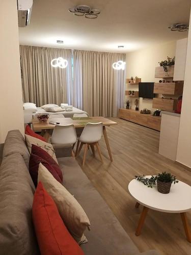 a living room with a couch and a table at Amazing Apartments @ Monastiraki Subway Station in Athens