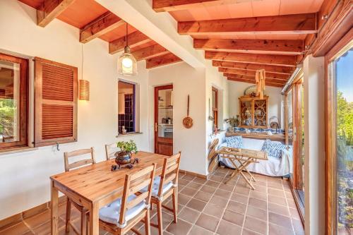 a dining room with a wooden table and chairs at Can Om in Campos