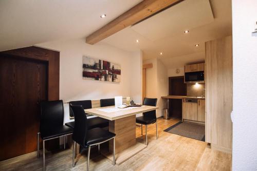 a kitchen and dining room with a table and chairs at Landhaus Gasser in Wenns