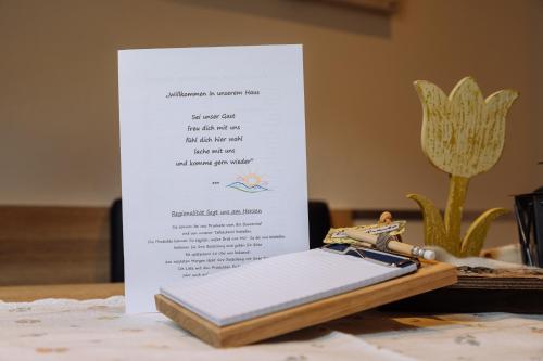 a book sitting on top of a table with a key at Landhaus Gasser in Wenns