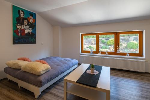 una sala de estar con un gran sofá azul y una mesa. en Apartmán U Křížku, en Jihlava