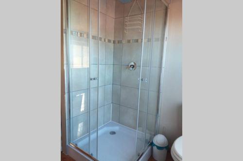a bathroom with a shower and a toilet at Whale of a Time - Sedgefield in Sedgefield