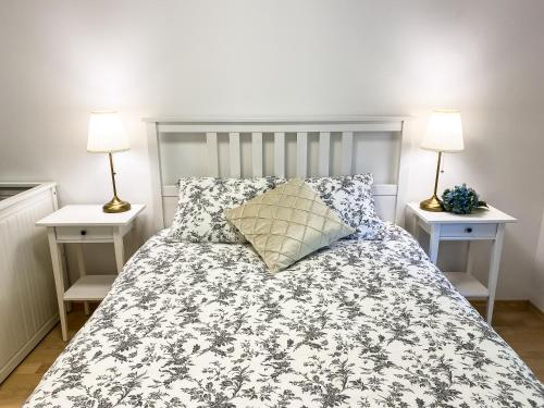 a bedroom with a bed with two night stands at Lakeview Villa Bled in Bled