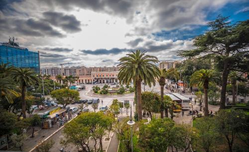 a busy city street with palm trees and buildings at Viasparano B&B in Bari