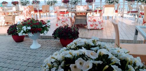 a bunch of flowers on a patio with tables and chairs at Shalanda in Odesa