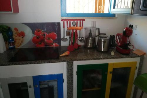 a kitchen counter with a colorful counter top at Palmahouse in Alghero