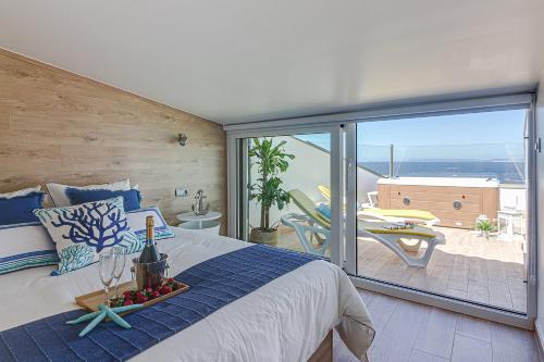 a bedroom with a bed with a view of a patio at Ribadomar Caion in A Coruña