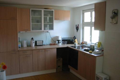 a kitchen with wooden cabinets and a counter top at Gemütliche Altstadtwohnung in Dinkelsbühl in Dinkelsbühl