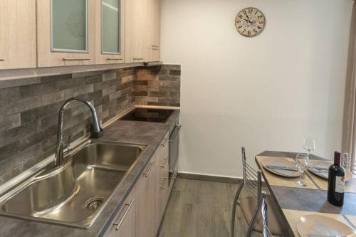 a kitchen with a sink and a counter top at Studio Anna in Káto Garoúna
